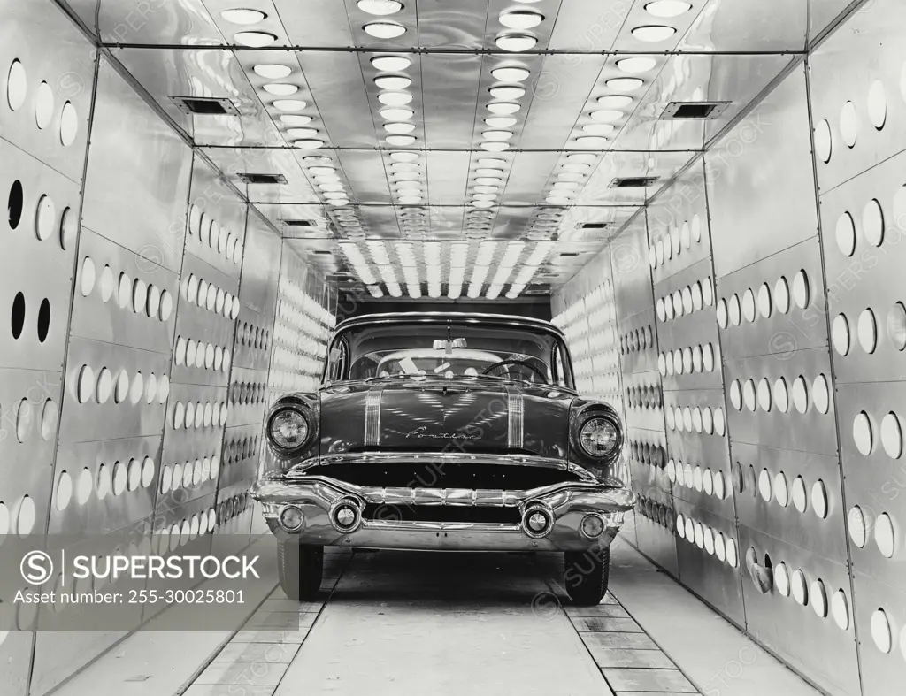 Vintage Photograph. A completed 1956 Pontiac makes its last run through paint oven after final inspection