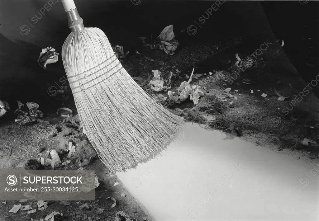 Vintage Photograph. Broom sweeps very dirty floor. Frame 6.