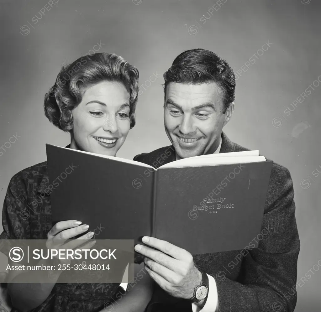 Vintage Photograph. Husband and wife going over the family budget. Frame 1