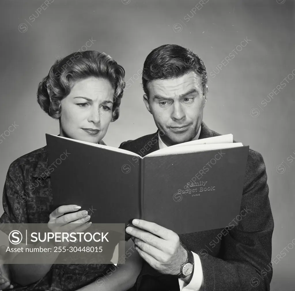 Vintage Photograph. Husband and wife going over the family budget. Frame 3