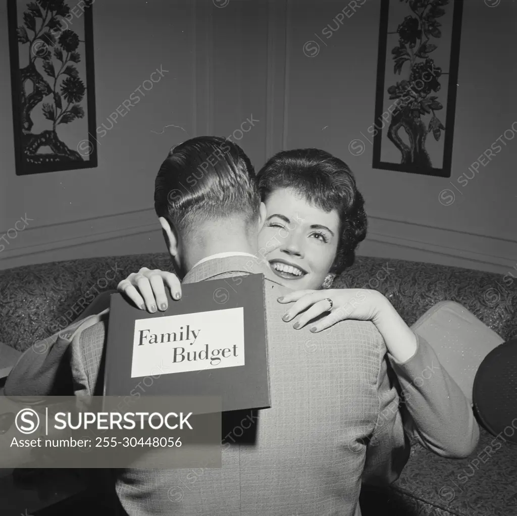 Vintage Photograph. Woman hugging husband and holding family budget. Frame 4