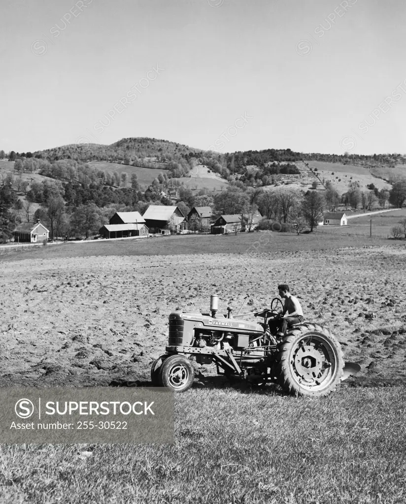 Farmer plowing a field with a tractor, Hartford, Vermont, USA