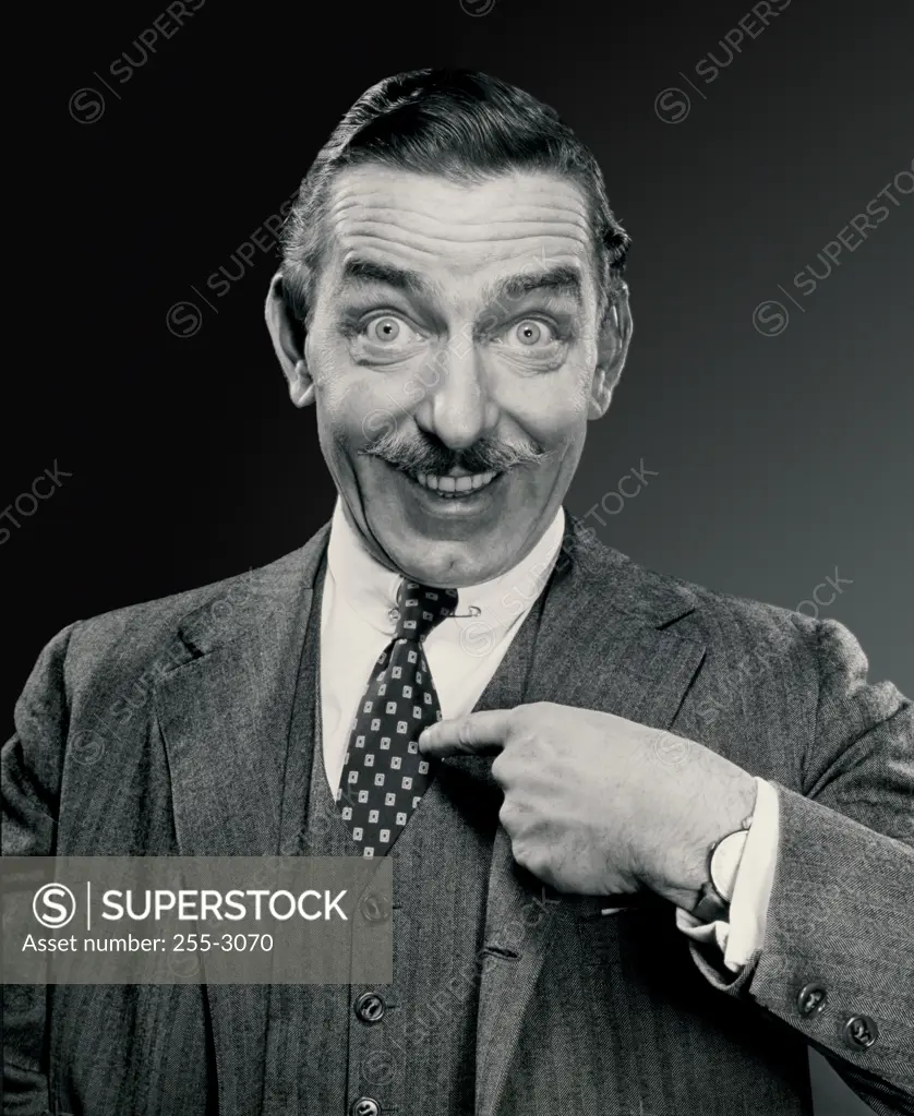 Portrait of a businessman pointing at himself