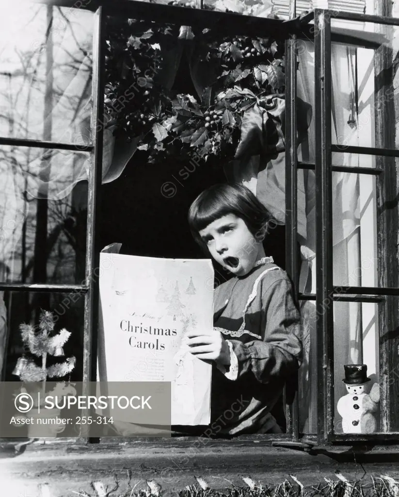 Girl sitting at the window and singing