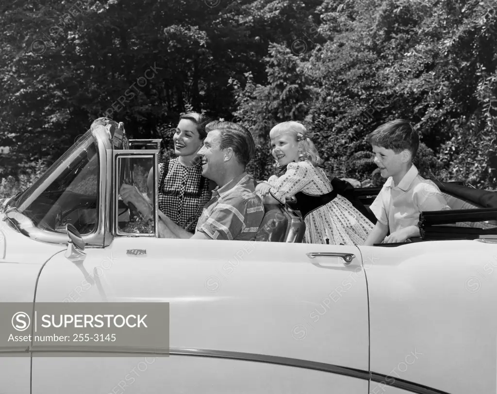 Parents and their children traveling in a car