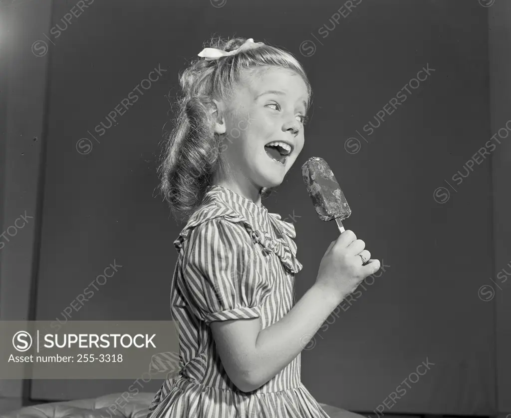 Vintage photograph. Side profile of a girl holding an ice-cream