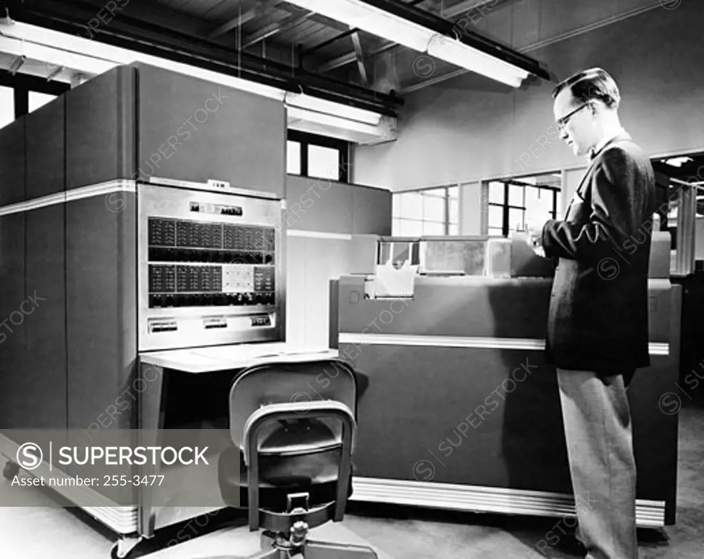 Side profile of a technician standing in front of a computer