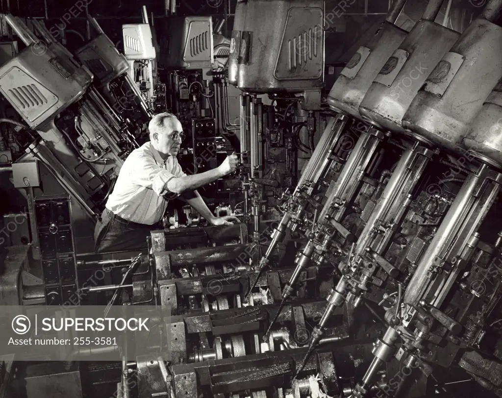 Side profile of a male working in a factory, Crankshaft Oil System Drill, Ford Motor Company, Dearborn, Michigan, USA