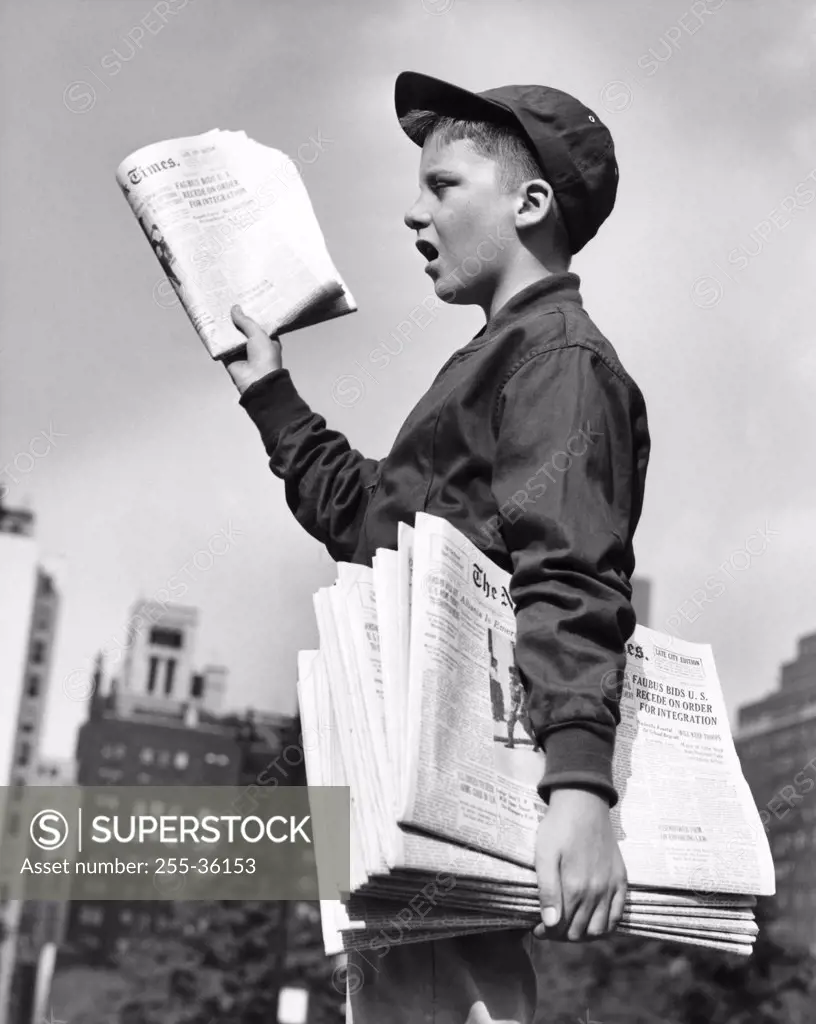 Teenage boy selling newspapers