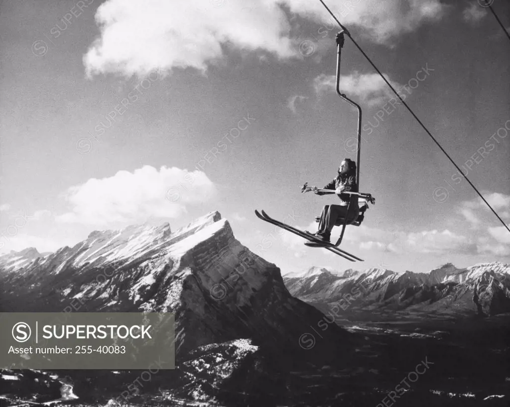 Skier sitting on a ski lift, Alberta, Canada