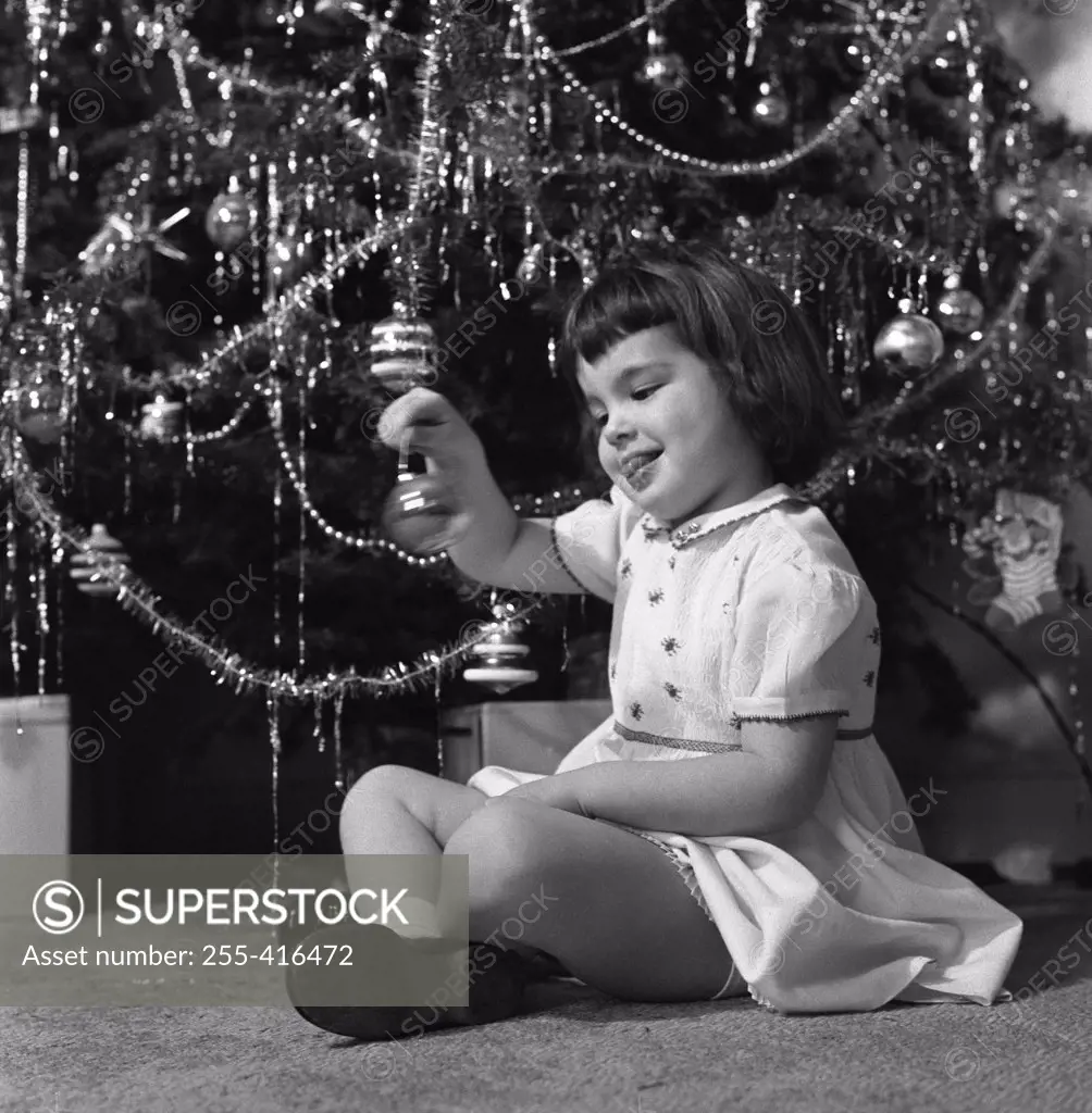 Small girl holding Christmas bauble