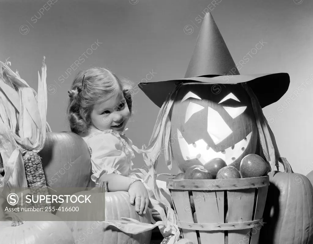 Girl around Halloween decorations, studio shot