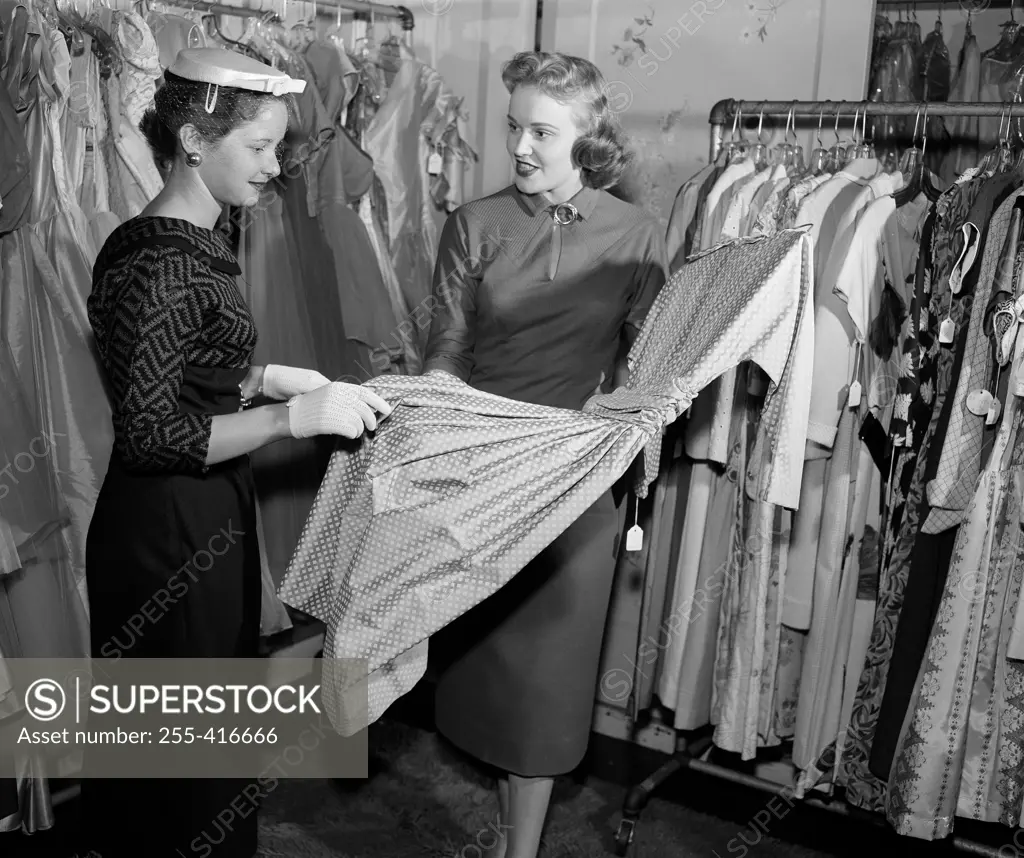 Woman choosing dress in shop