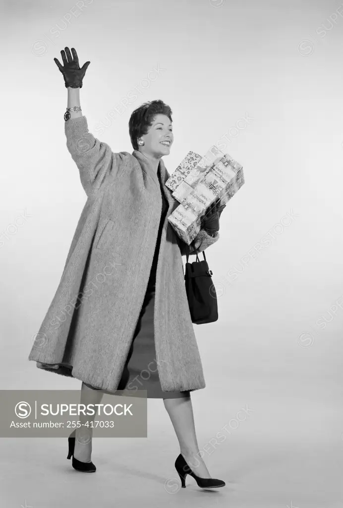 Studio shot of mid adult woman with shopping