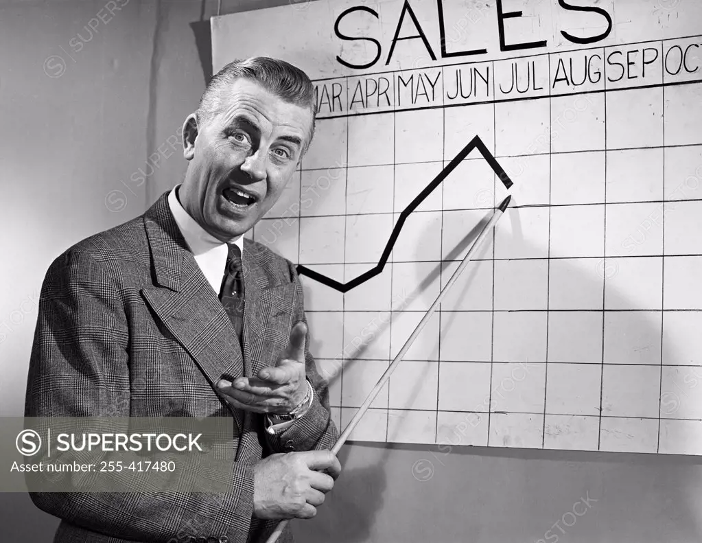 Businessman pointing at sales chart