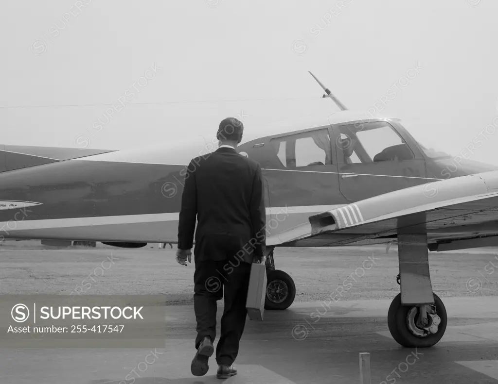 Businessman approaching private plane