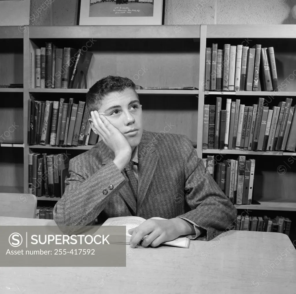 School boy reading in library