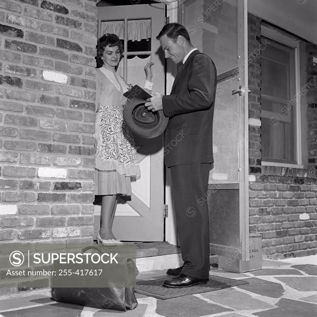 Salesman with woman at front door