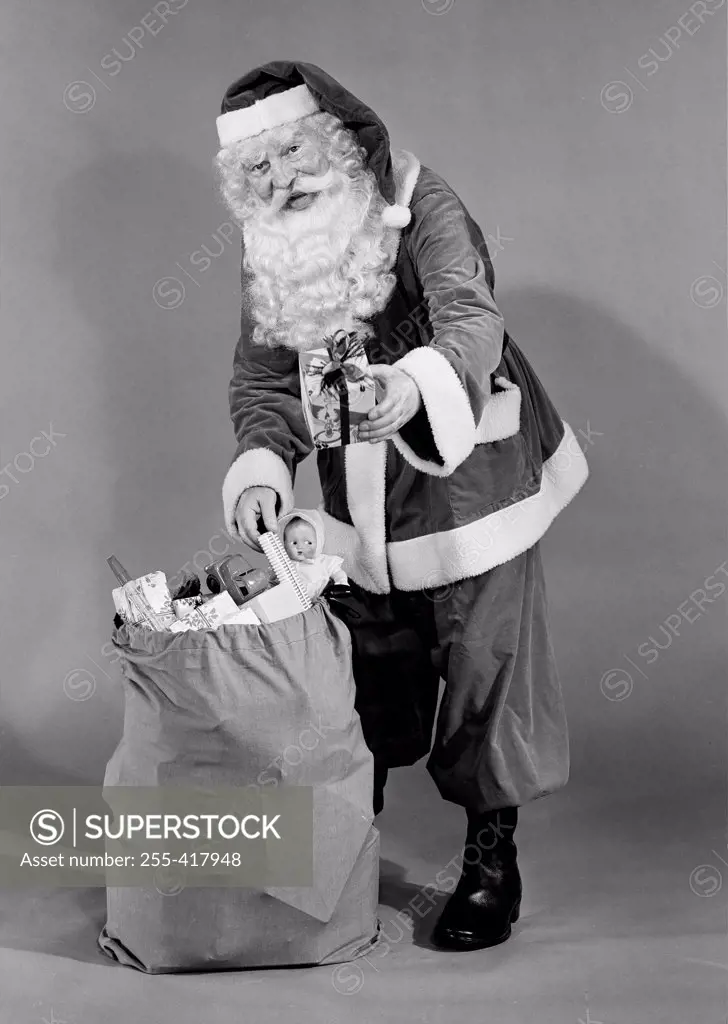 Father christmas pulling present from sack