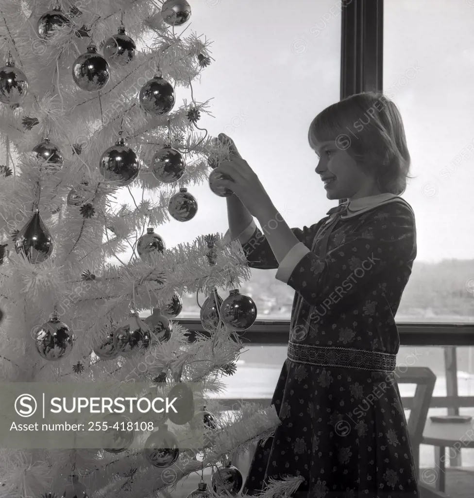 Girl decorating Christmas tree