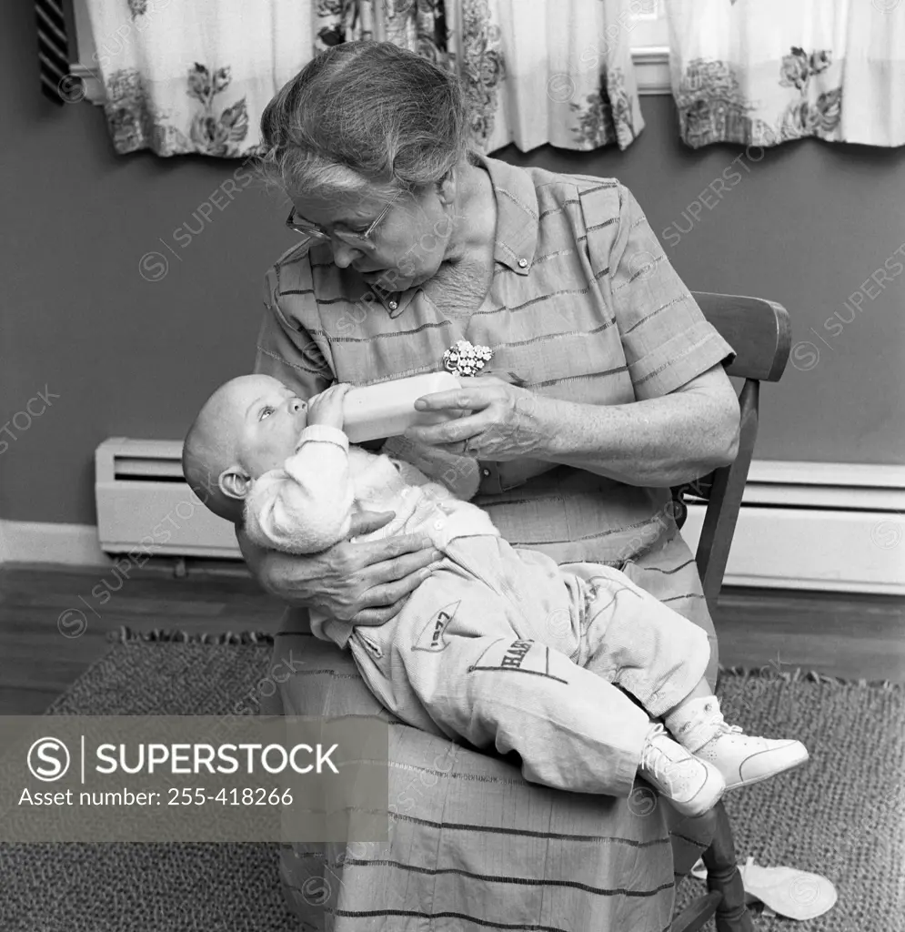 Grandmother feeding baby