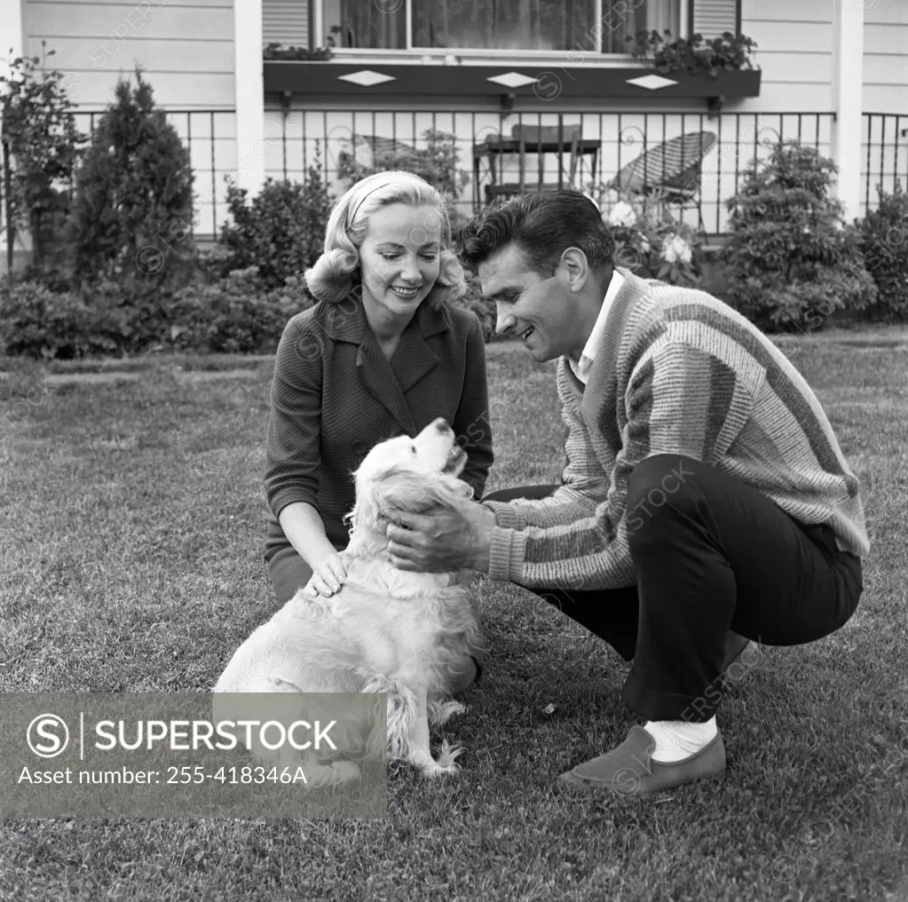 Couple playing with dog