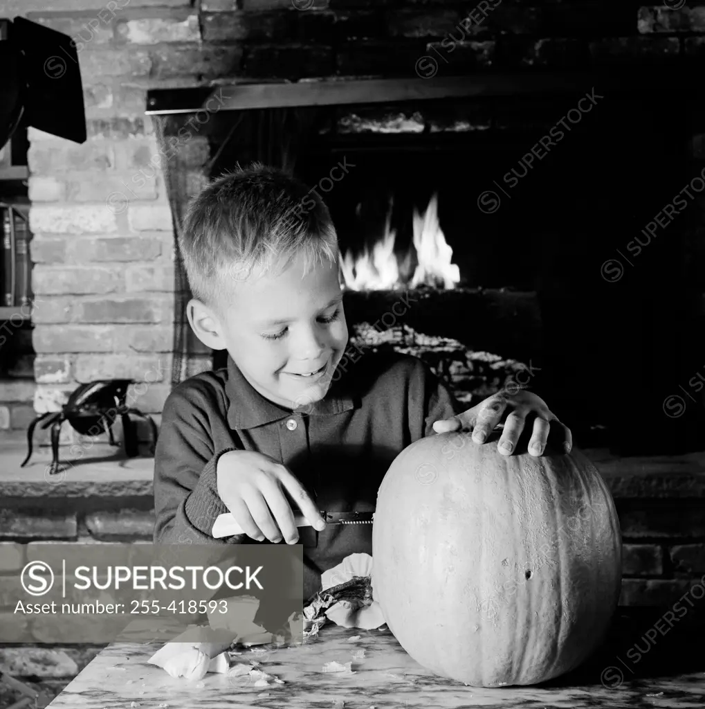 Boy preparing pumpkin for Halloween