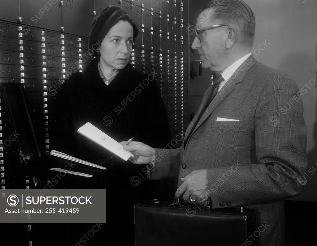 Widow and her attorney going over contents of safe deposit box