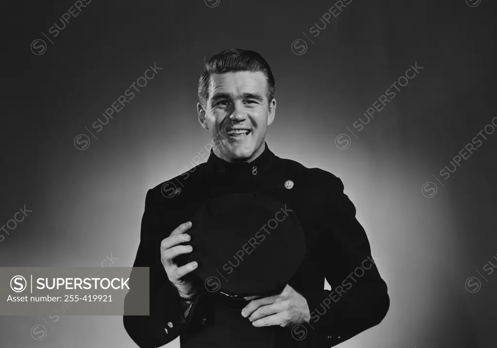 Portrait of mature smiling man in uniform, studio shot