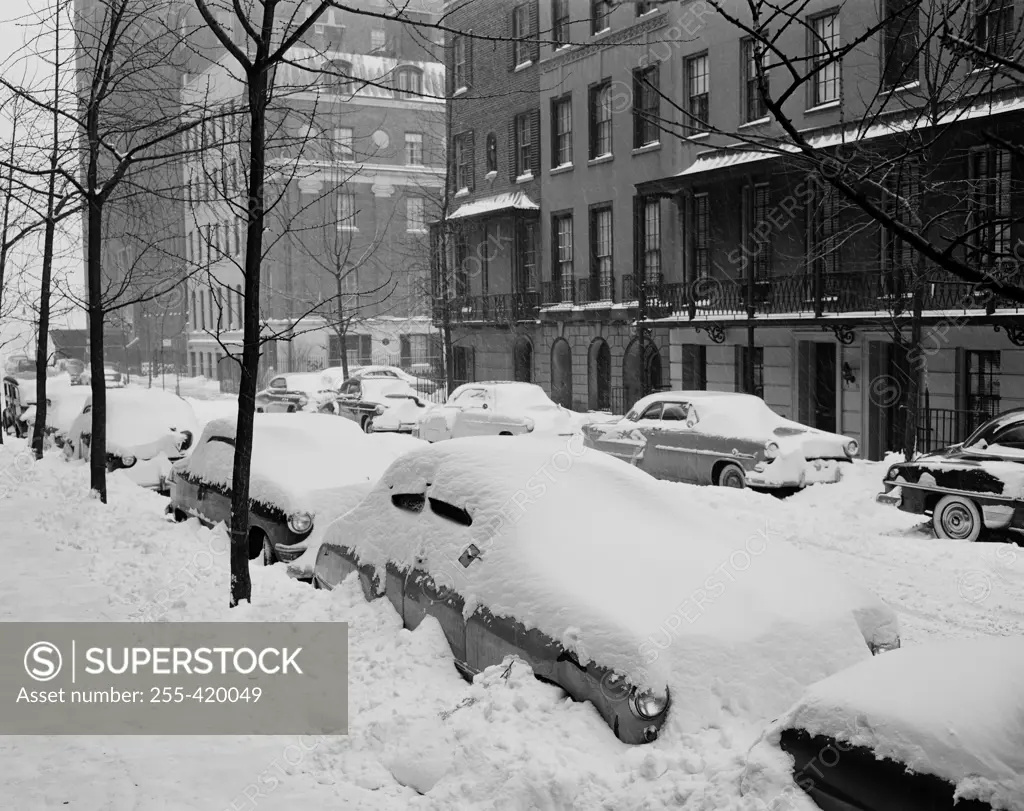 USA, New York State, New York City, Beekman Place on East side near 51st Street, snow covered automobiles line curbs