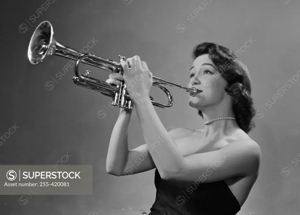 Young woman playing trumpet