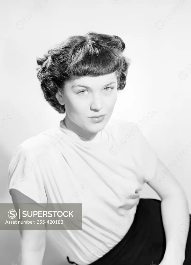 Studio portrait of young woman sitting