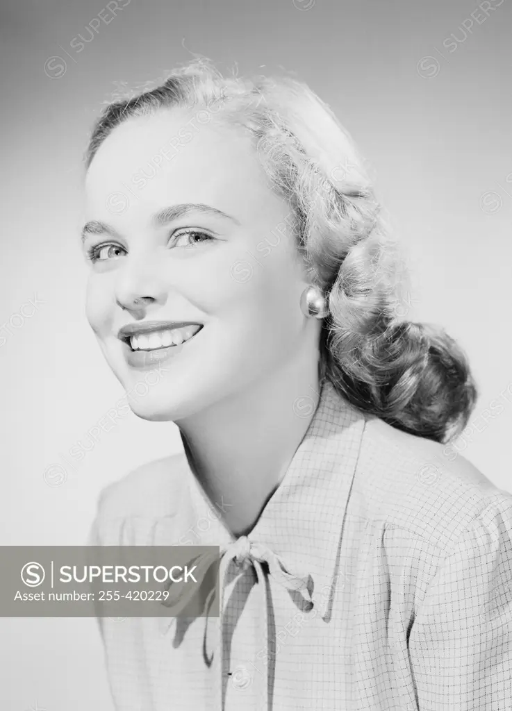 Studio portrait of young woman smiling