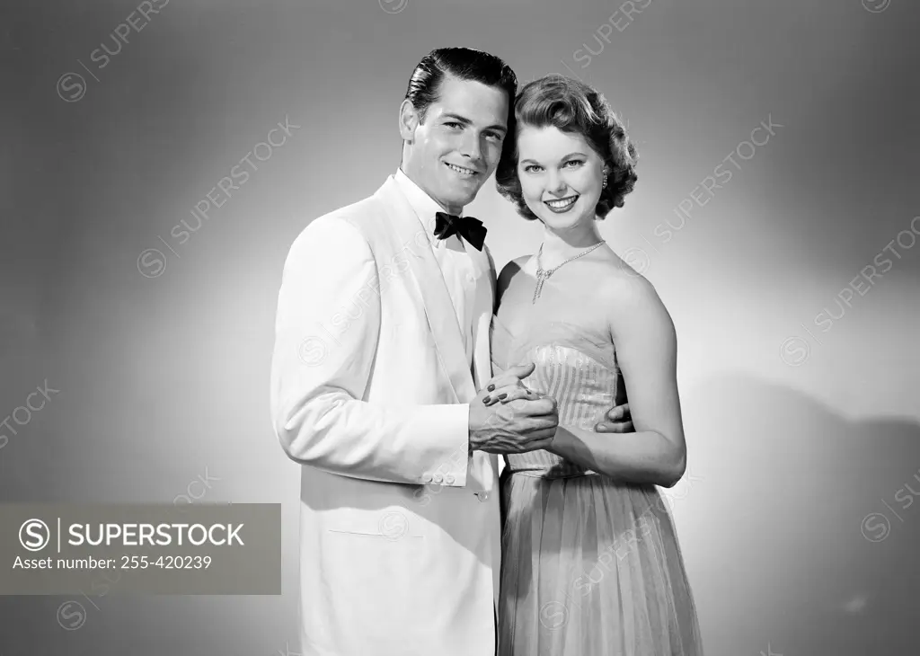 Studio portrait of young couple dancing