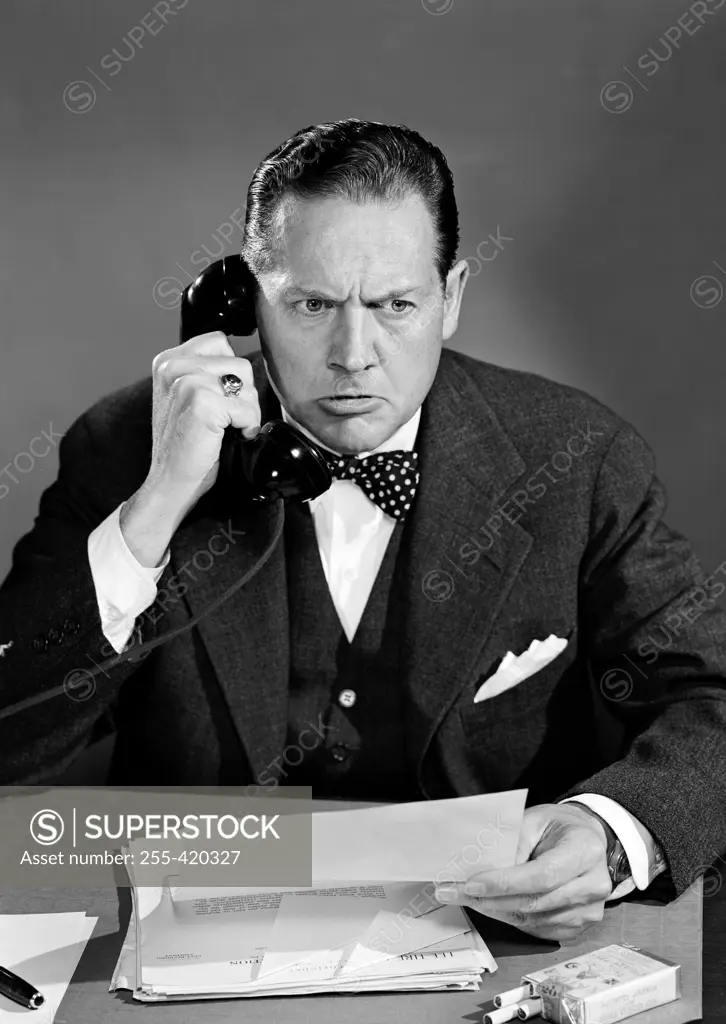 Businessman using office telephone