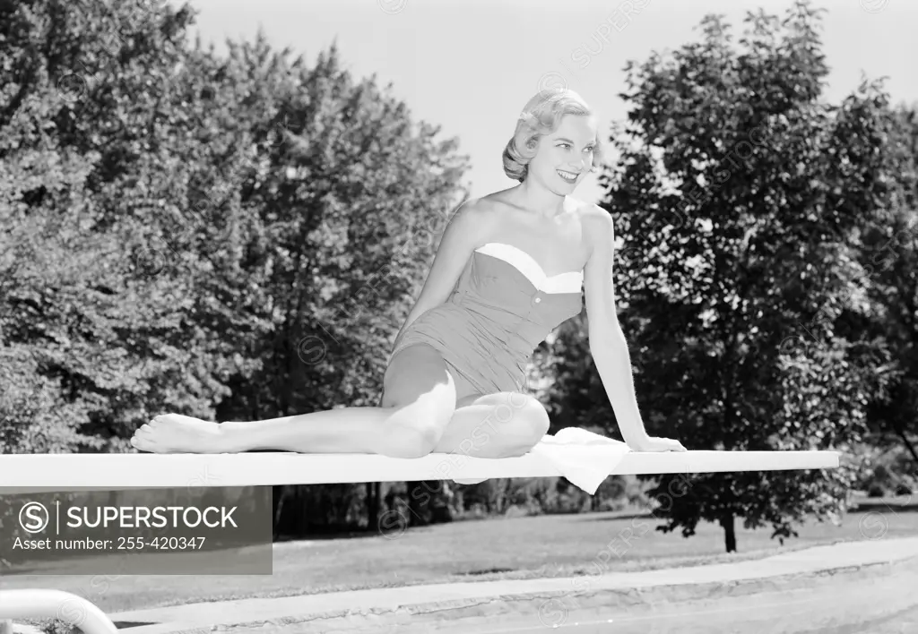 Young woman in swimming costume on diving board