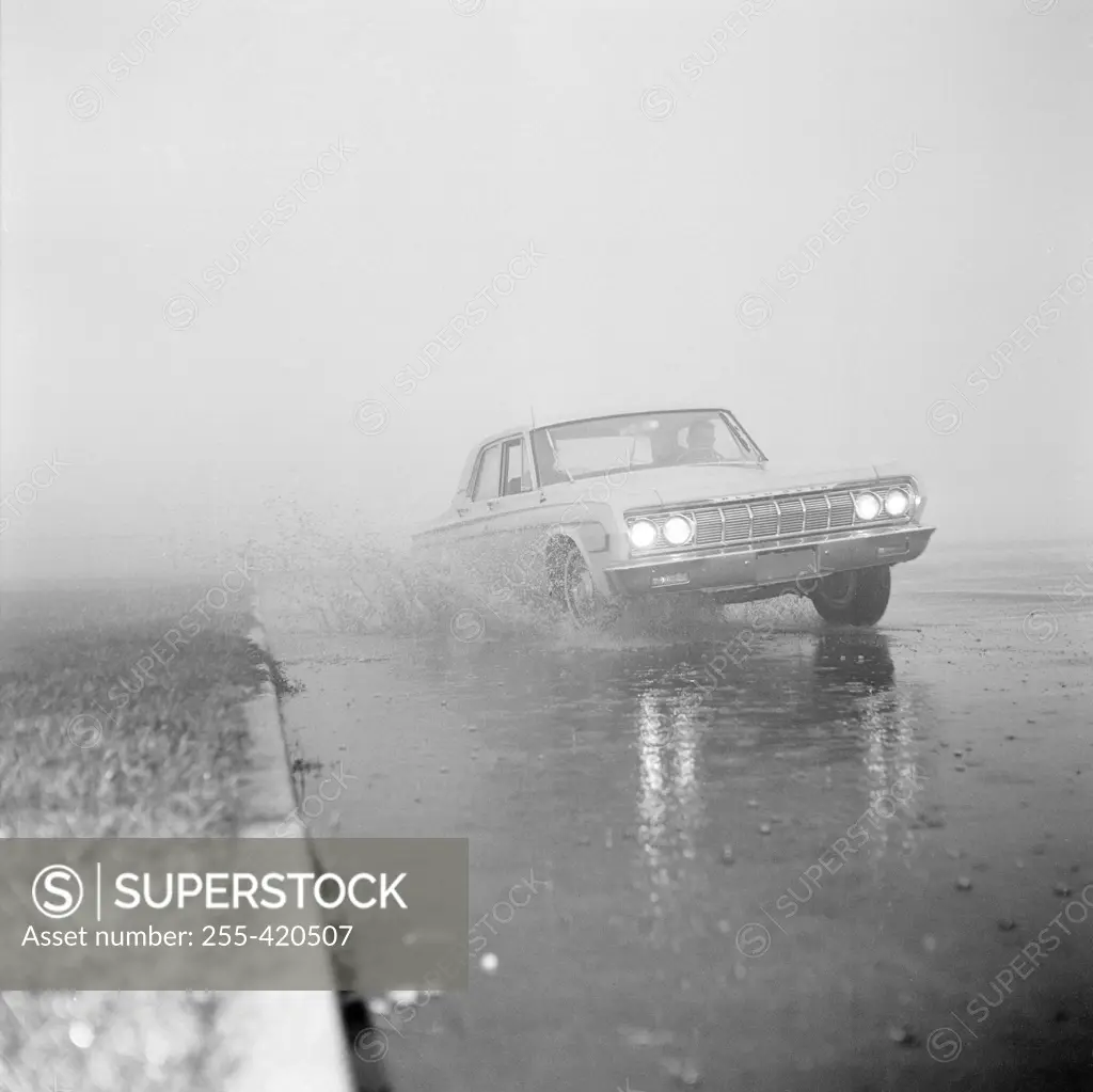 Car on foggy winter road