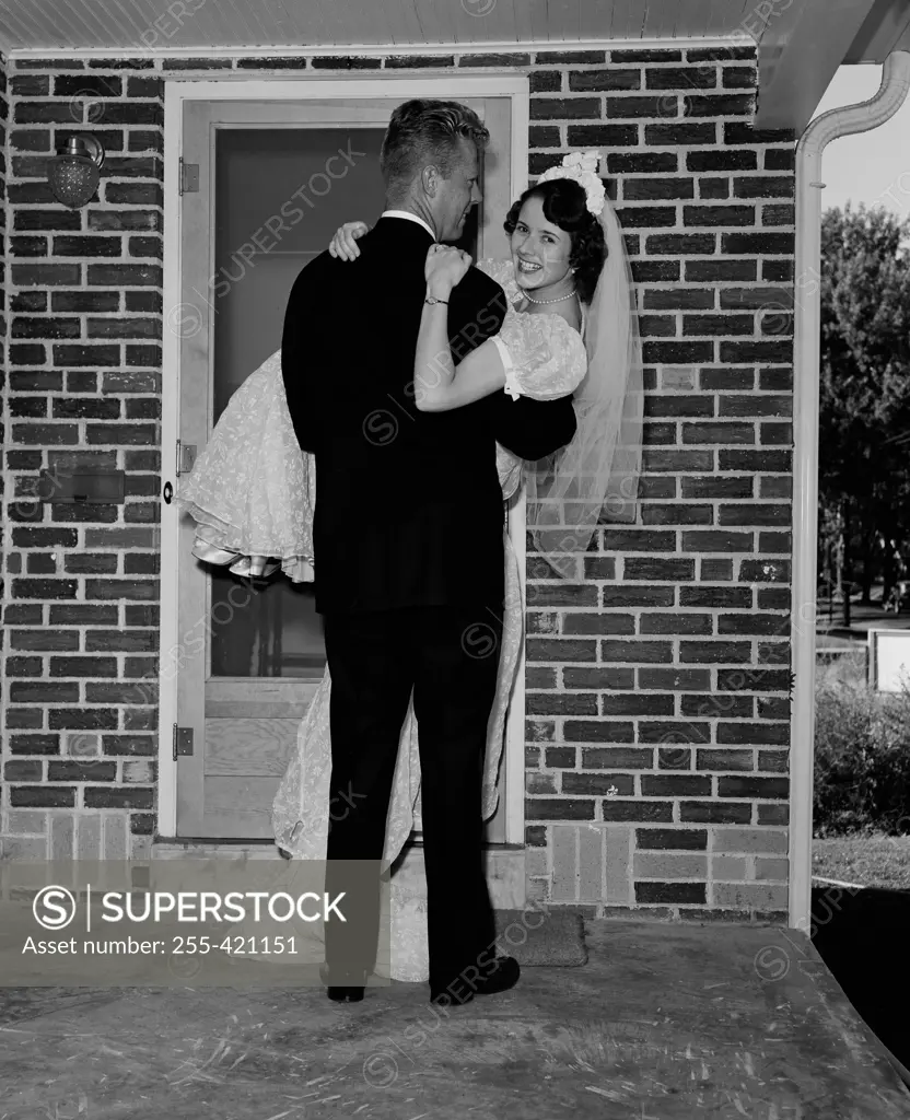 Groom carrying bride