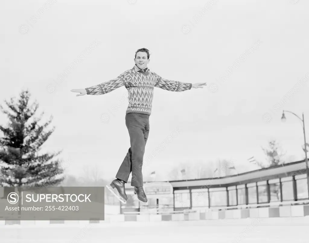 Man jumping while ice skating