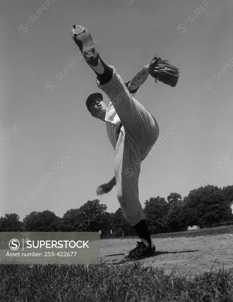 Baseball pitcher standing on one leg