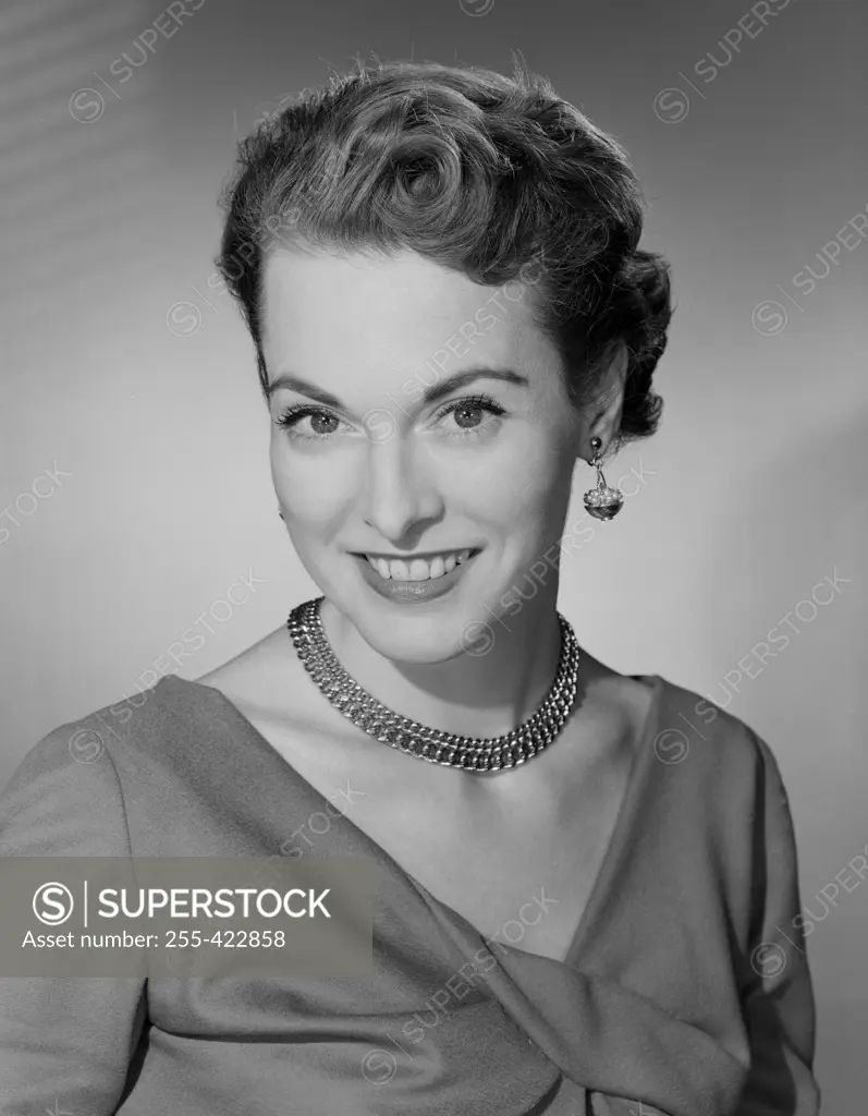 Studio portrait of mid adult woman smiling