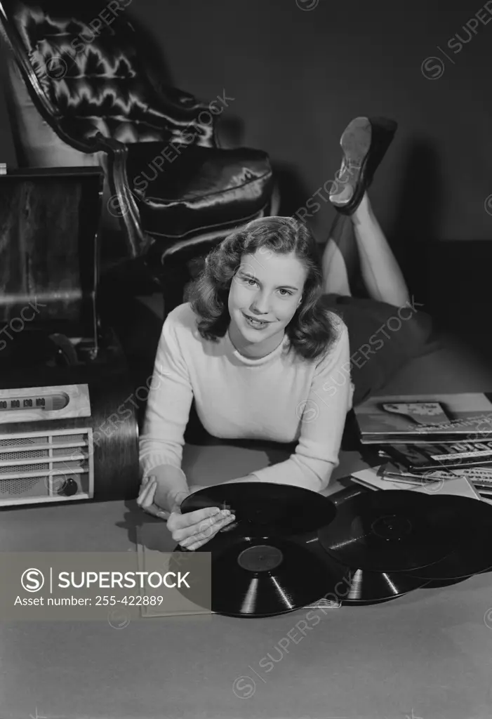 Studio portrait of young woman with records.