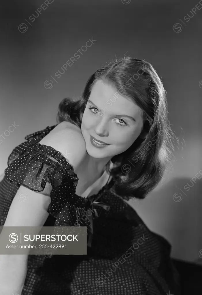 Studio portrait of young woman smiling