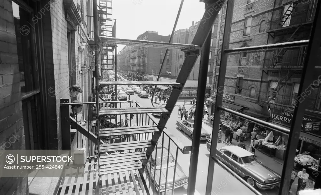 USA, New York State, New York City, View through fire escape looking down on shoppers along Orchard Street