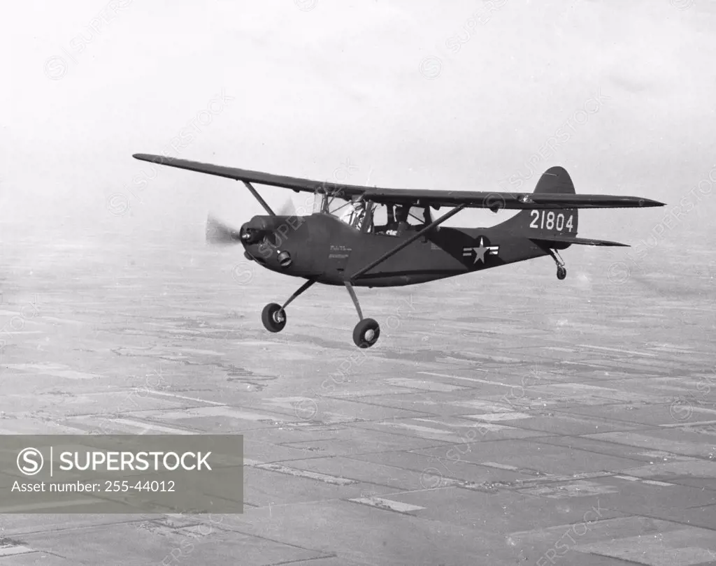 Side profile of a military airplane in flight, XL-19B