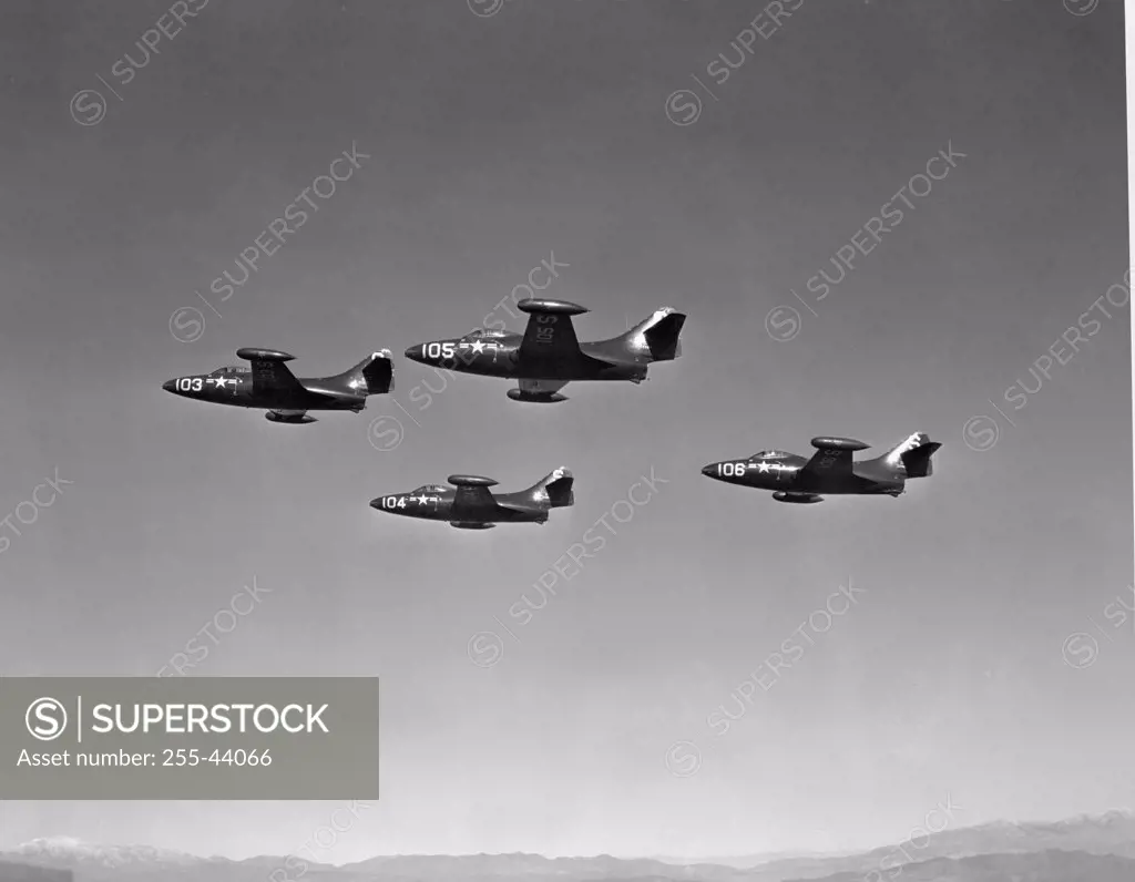 Low angle view of four fighter planes flying in formation, F9F Panther