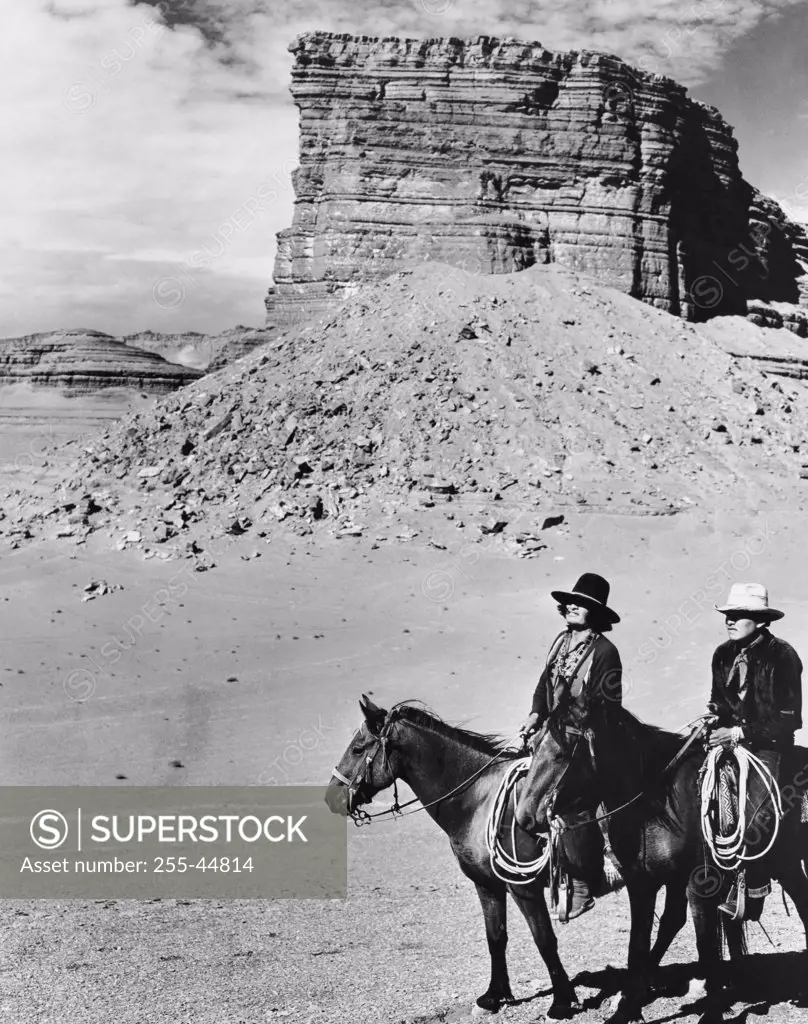 Two Navajo men riding horses