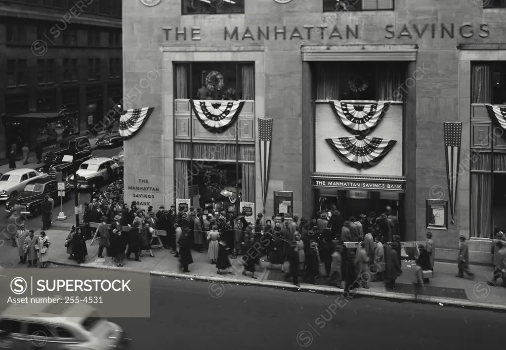 Vintage Photograph. View of downtown with people lined around the Manhattan Savings Bank