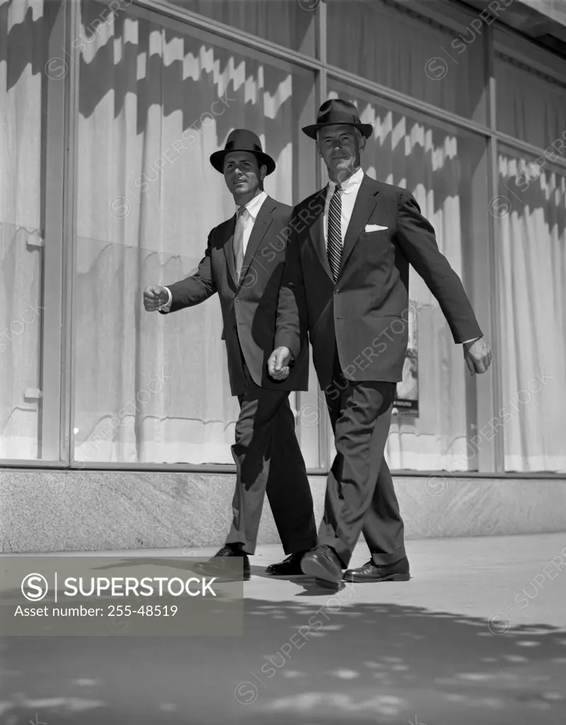 Two businessmen walking on street