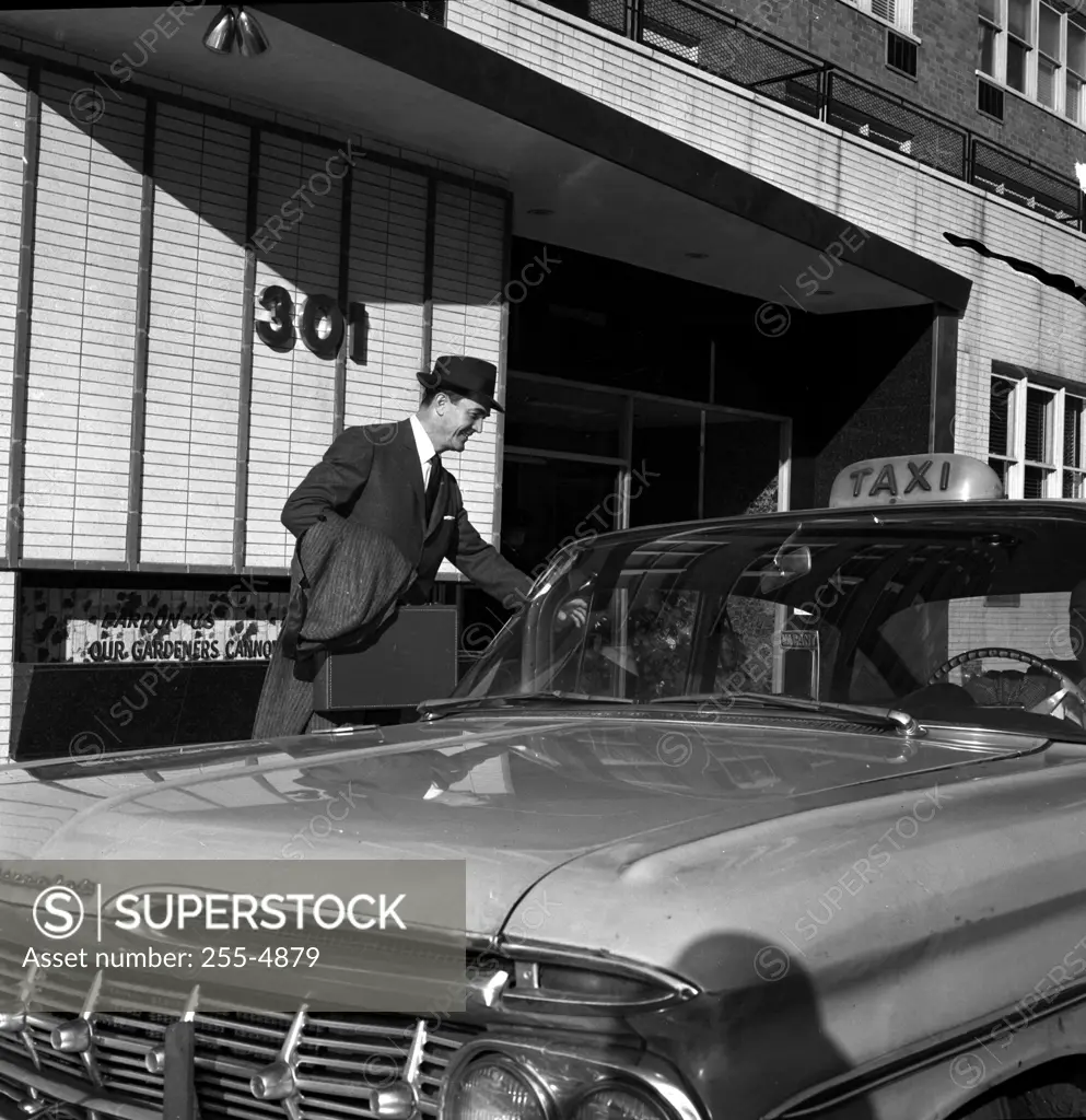 Men entering into taxi